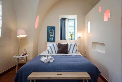 a bedroom with a bed with two towels on it at La Maison des Sources in ‘Ayn Zḩaltā