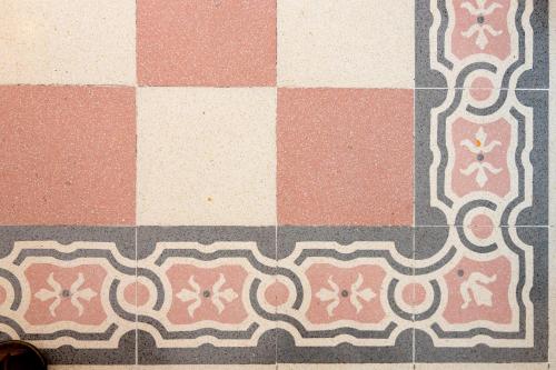 a floor with pink and white tiles on it at Dimora La Torre Room in Favignana