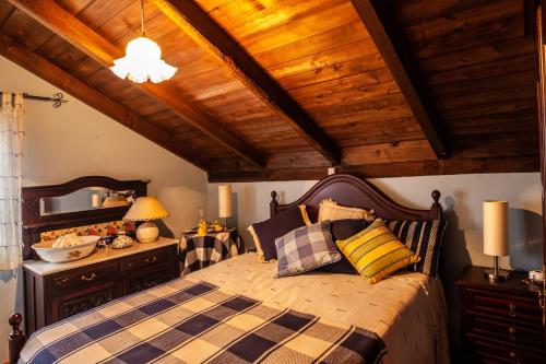 a bedroom with a bed and a wooden ceiling at Chalet Pico das Pedras in Santana