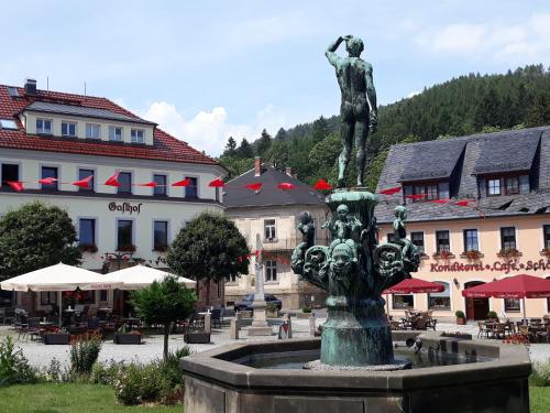 a statue of a man standing on top of a fountain at Gasthof Hillig in Bad Gottleuba