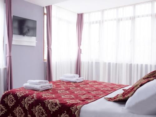 a bedroom with a red bed with towels on it at The Zanadu İstanbul in Istanbul