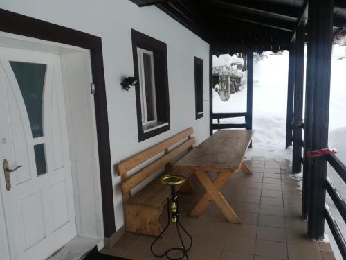 a room with a wooden bench and a table at Casa de Vacanţă Vârtop in Vartop