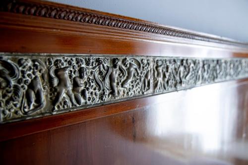 a wooden wall with a carving of animals on it at Dimora La Torre Room in Favignana