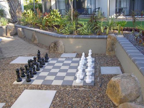 a chess board on a garden chess board at Island Leisure Resort in Nelly Bay