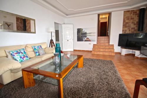 a living room with a couch and a coffee table at Villa Mar in El Campello