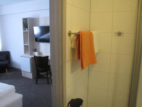 a bathroom with a towel hanging on the wall at Milano Hotel in Hamburg