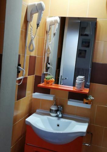 a bathroom with a sink and a mirror at B&B Sweet Home Two Steps From The Ruins... in Pompei