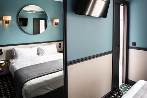 Cama ou camas em um quarto em Lenox Montparnasse