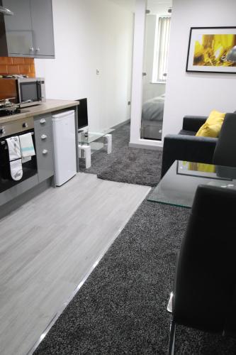 a living room with a couch and a table at Halifax House, Studio Apartment 214 in Halifax