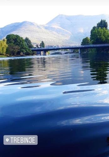 a body of water with a bridge in the background at Apartman Ana 2 in Trebinje