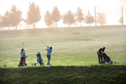 a group of people playing golf on a golf course at Wellness Hotel Svachovka in Český Krumlov