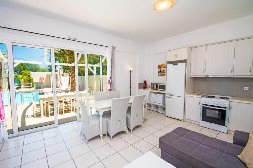 a kitchen with a table and a dining room with a view at Almirikia in Pigianos Kampos