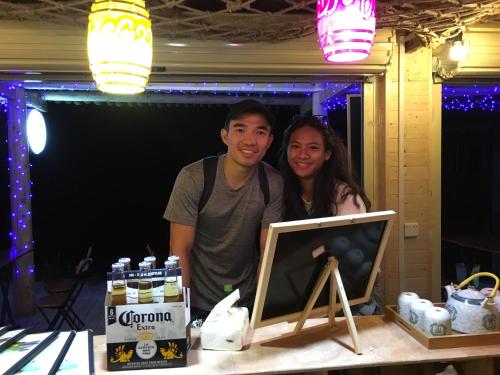 a man and a woman standing next to a table at Longji Terrace La vie Inn in Longsheng