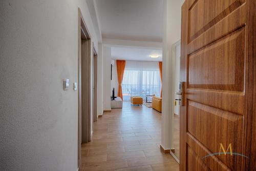 a hallway with a door and a living room at M Apartments in Bar