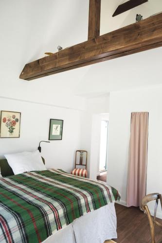 a bedroom with a bed with a striped blanket at meinsachsenwald forsthaus friedrichsruh in Aumühle
