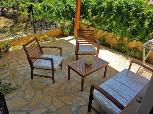 a group of chairs and tables on a patio at Apartments Milevčić in Jelsa