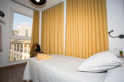 a bedroom with a bed and a large window at Los Palomitos, Casco Histórico VT-47255-V in Gandía