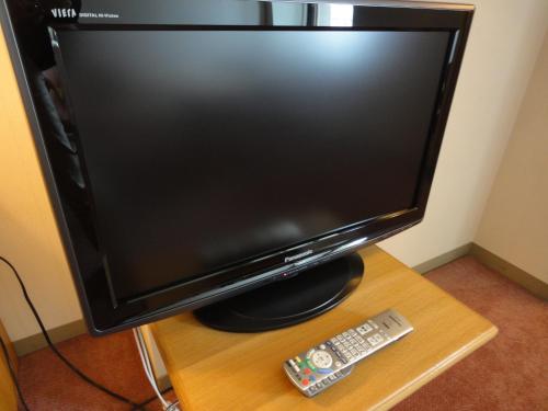 a television monitor and a remote control on a table at Kasuitei in Yonago