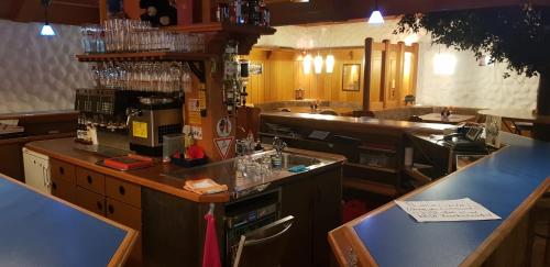 a kitchen with a counter with a coffee maker on it at Alemannenhof Hotel Engel in Rickenbach