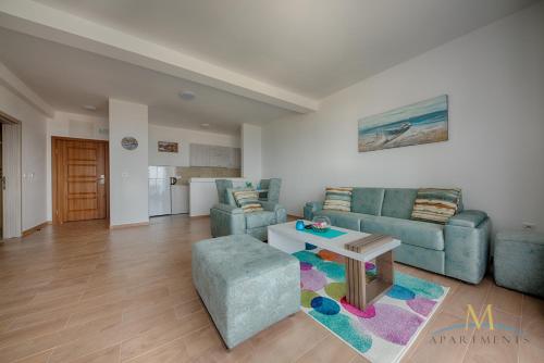 a living room with a couch and a table at M Apartments in Bar