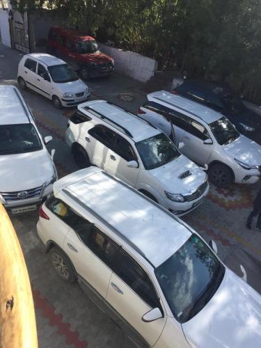 a group of cars parked in a parking lot at Hotel Rezang-La in Leh