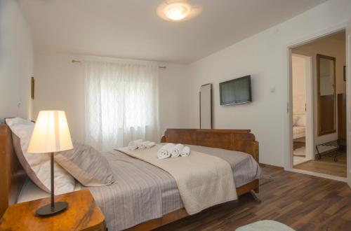 a bedroom with a bed with two towels on it at Spartion Marine in Split