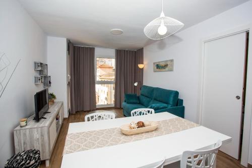 a living room with a white table and a blue couch at Los Palomitos, Casco Histórico VT-47255-V in Gandía