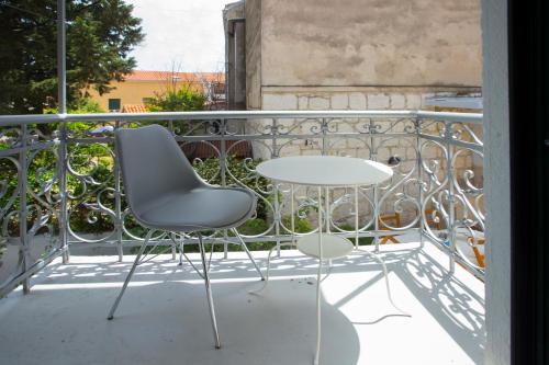 a table and two chairs on a balcony at Spartion Marine in Split