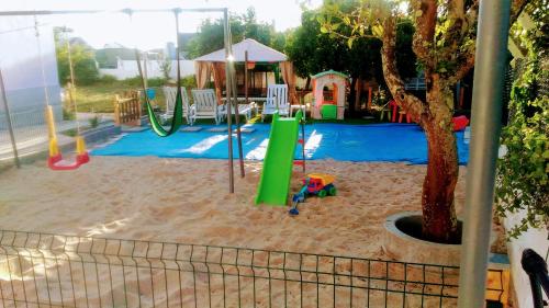 a childrens playground with a slide at Visitar Bioucas I - Casa Inteira Familiar in Bioucas