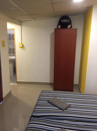 a room with a bed and a wooden door at Villa Eco Green Airport in Katunayake