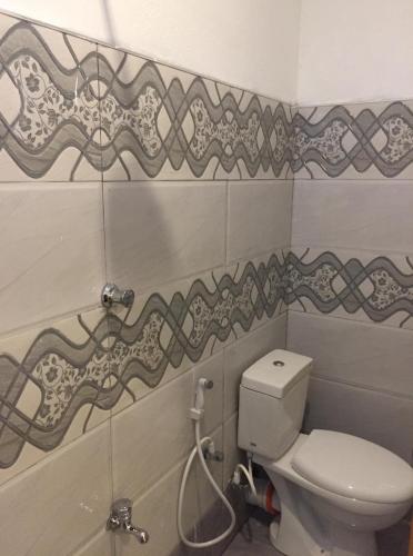 a bathroom with a toilet and a shower at Villa Eco Green Airport in Katunayake