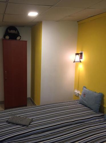 a bedroom with a bed with a blue pillow and a door at Villa Eco Green Airport in Katunayake
