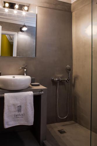 a bathroom with a sink and a shower at Aethra Boutique Rooms in Nafplio