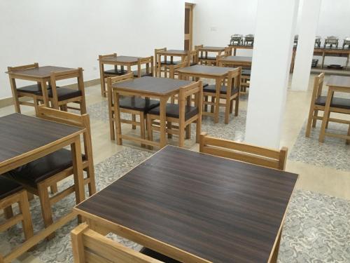 a group of tables and chairs in a room at Hotel Rezang-La in Leh