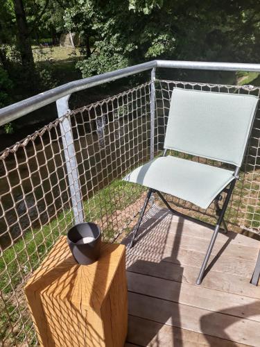 a white chair sitting on top of a deck at Péitche Lauer in Useldange