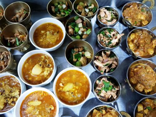 a bunch of cups filled with different types of food at Nepal Pavilion Inn in Kathmandu