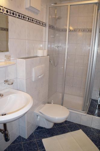 a bathroom with a toilet and a shower and a sink at Pension Strolz in Sankt Anton am Arlberg
