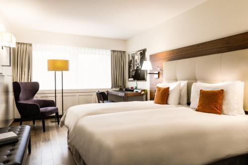 Ένα ή περισσότερα κρεβάτια σε δωμάτιο στο Hotel Astoria