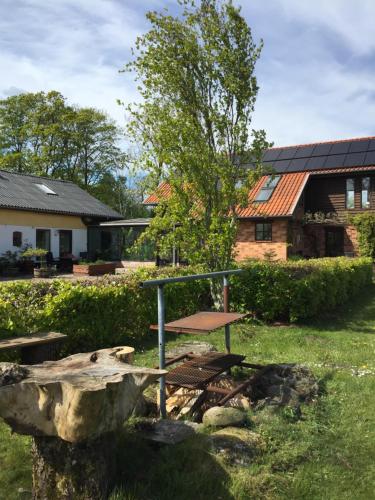 a picnic table and a rock in front of a house at Anesminde in Give