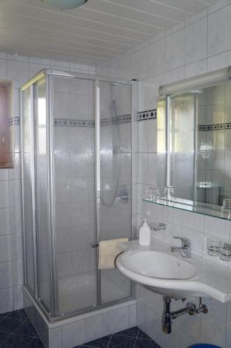 a bathroom with a sink and a shower at Pension Strolz in Sankt Anton am Arlberg