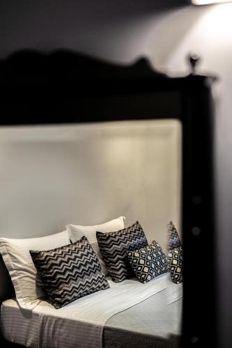 a black and white couch with pillows on it at Aethra Boutique Rooms in Nafplio