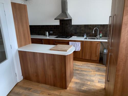 a kitchen with a counter top and a sink at The Village Tavern Apartment in Larkhall