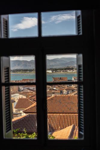a view from a window of a building with tile roofs at Aethra Boutique Rooms in Nafplio