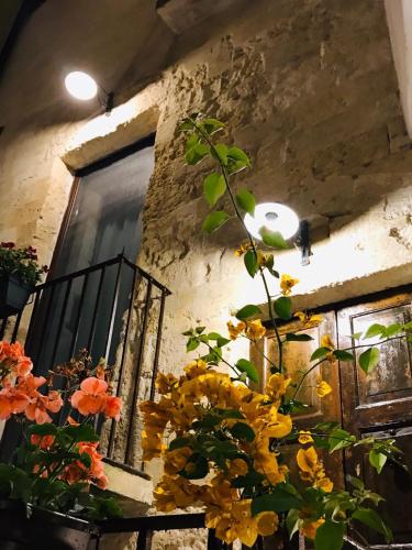 a bunch of flowers in a vase next to a window at Ponticelli B&B Boutique in Gravina in Puglia