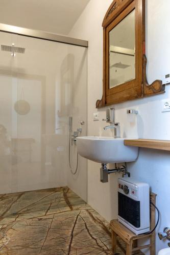 a bathroom with a sink and a mirror at On the River in Laives