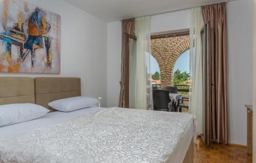 a bedroom with a bed and a view of a balcony at Apartments Marizela in Poreč
