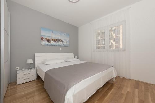 Posteľ alebo postele v izbe v ubytovaní Apartman IVONA