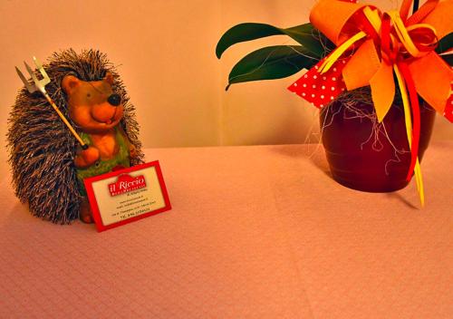 a toy hedgehog sitting on a table next to a vase at Bed And Breakfast Il Riccio in Ceva