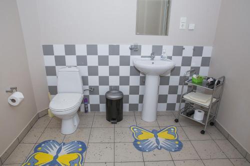 a bathroom with a toilet and a sink at Dzeņi in Amatciems