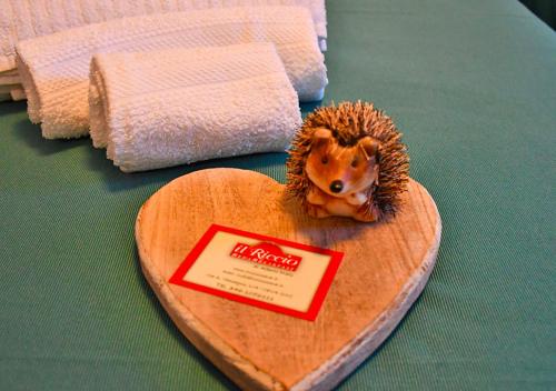 a hedgehog on a wooden heart on a table at Bed And Breakfast Il Riccio in Ceva